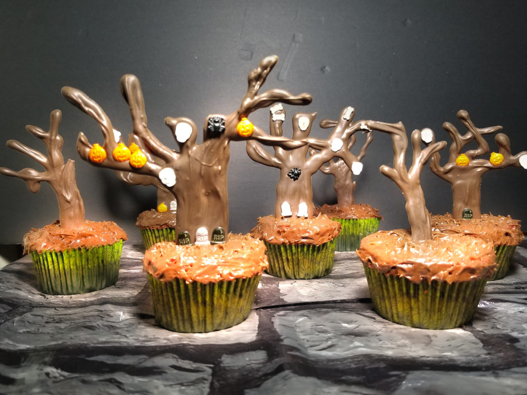 How to Make Delicious Creepy Tree Cupcakes. These cupcakes are the perfect blend between delicious and creepy. Chocolate trees are decorated and add an awesome look to the plain cupcakes. It's such a fun project to make with everyone!