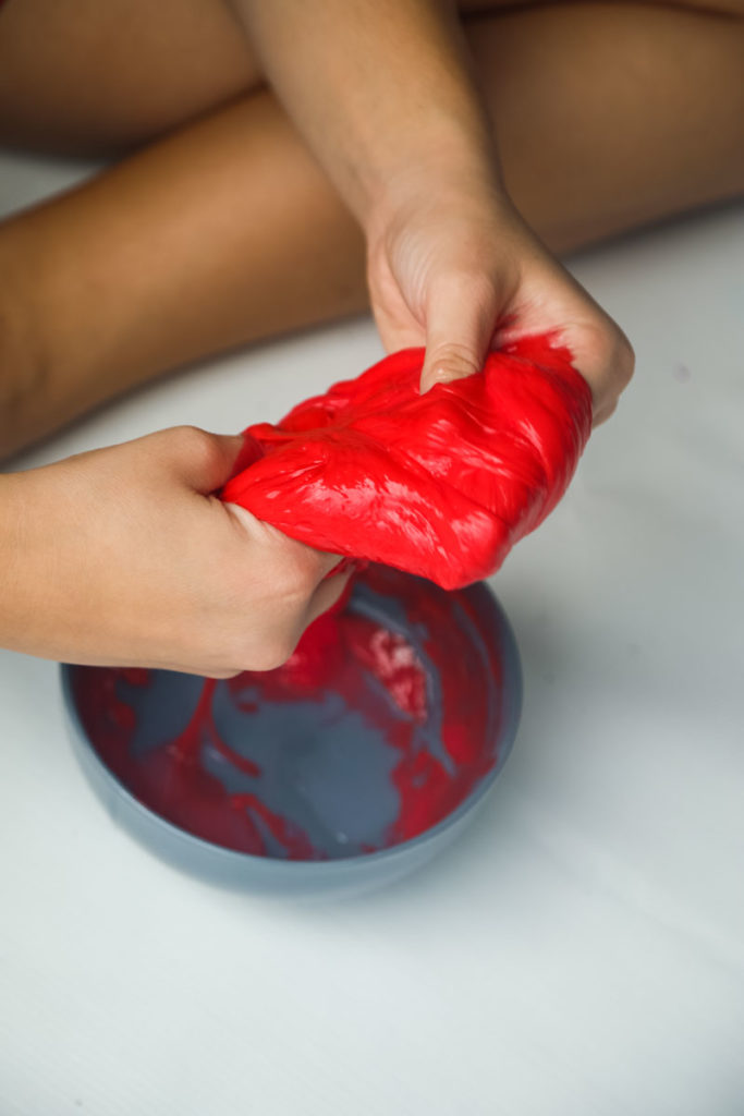 How to Make Easy Slime Recipe- Oozing Blood Slime for Halloween. The best Halloween slime recipe using no Borax! Perfect for Halloween crafts & Parties. Learn how to make this gross looking slime by reading our post, it includes step by step instructions & a video!